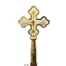 golden cross on a wooden stick